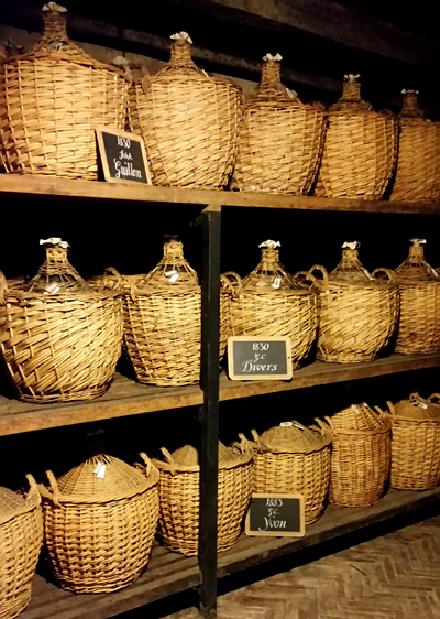 Eaux de vie in statis in glass demijohns.