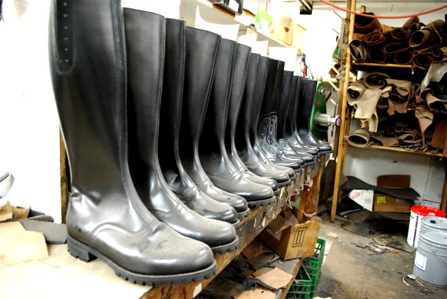 A row of police boots under construction at Nick's Shoe Repair